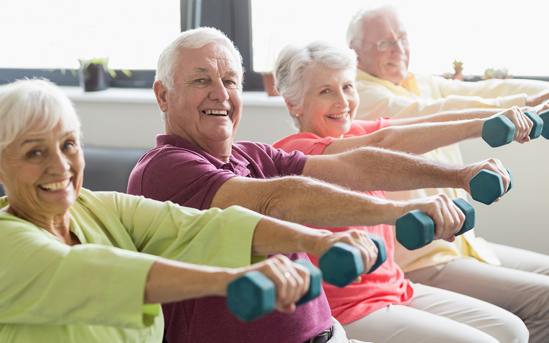 Seniors using free weights at a gym